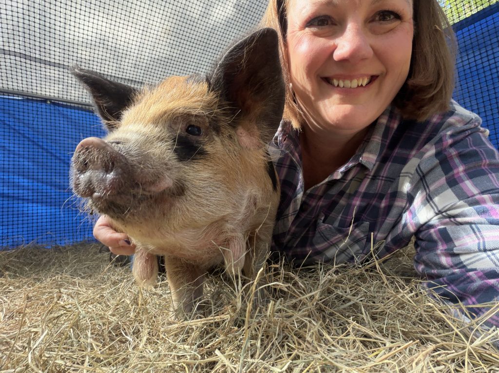 Wife smile with Randi, our female kunekune.